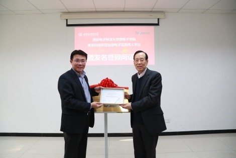 A person holding a sign posing for the camera

Description generated with high confidence