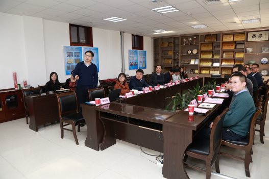 A group of people sitting at a table in a room

Description generated with very high confidence