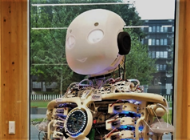 A picture containing window, table, building, sitting

Description automatically generated