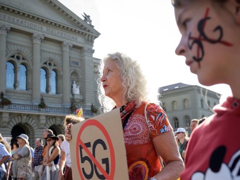 People take part in a nationwide protest against the 5G technology and 5G-compatible antennae deployment on 21 September in front of the Swiss House of Parliament in Bern.